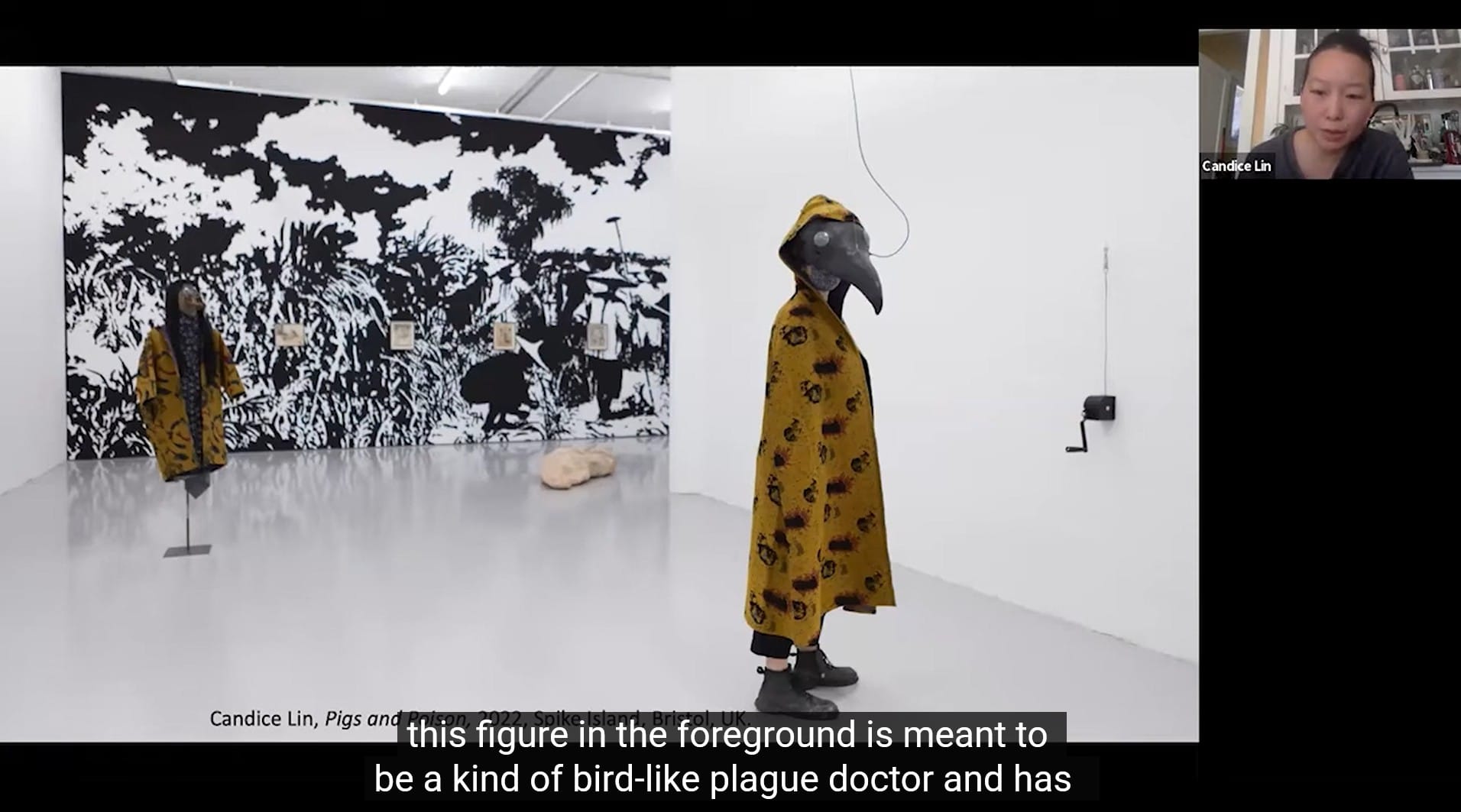 still from the conversation on "a history of future contagion" showing candice lin's exhibition. subtitle reads: "this figure in the foreground is meant to be a kind of bird-like plague doctor and has-"
